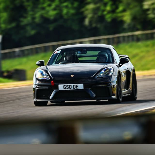 Black sports car on racetrack, featuring UK plate and performance parts, Eastwood Engineering