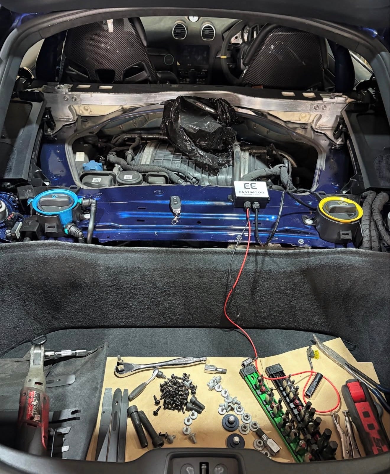 Eastwood Engineering exhaust valve controller installation on car engine with tools and parts