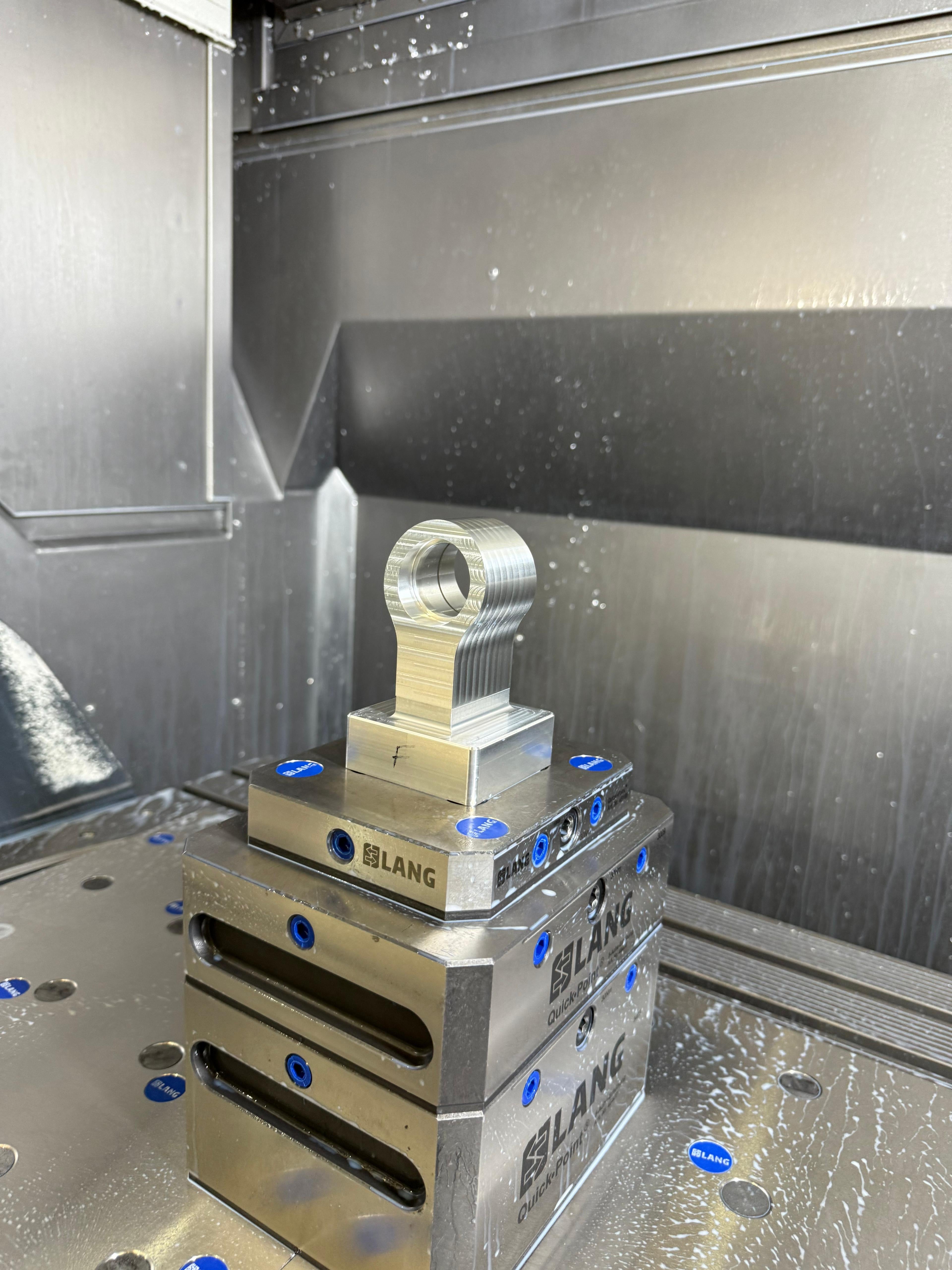 CNC-machined metal valve controller part on Lang vice at Eastwood Engineering UK workshop