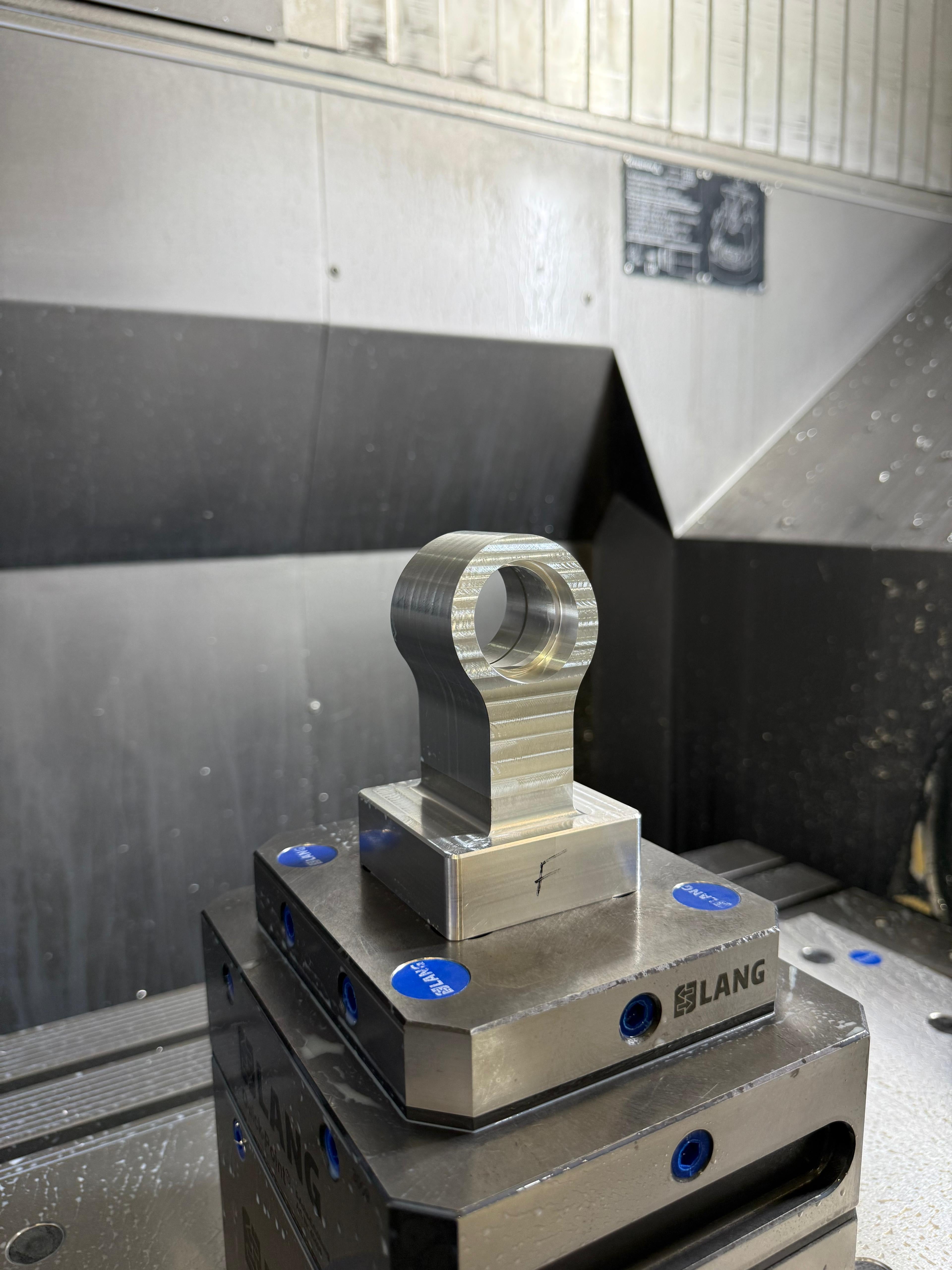 CNC machined valve controller component on metal fixture in Eastwood Engineering workshop