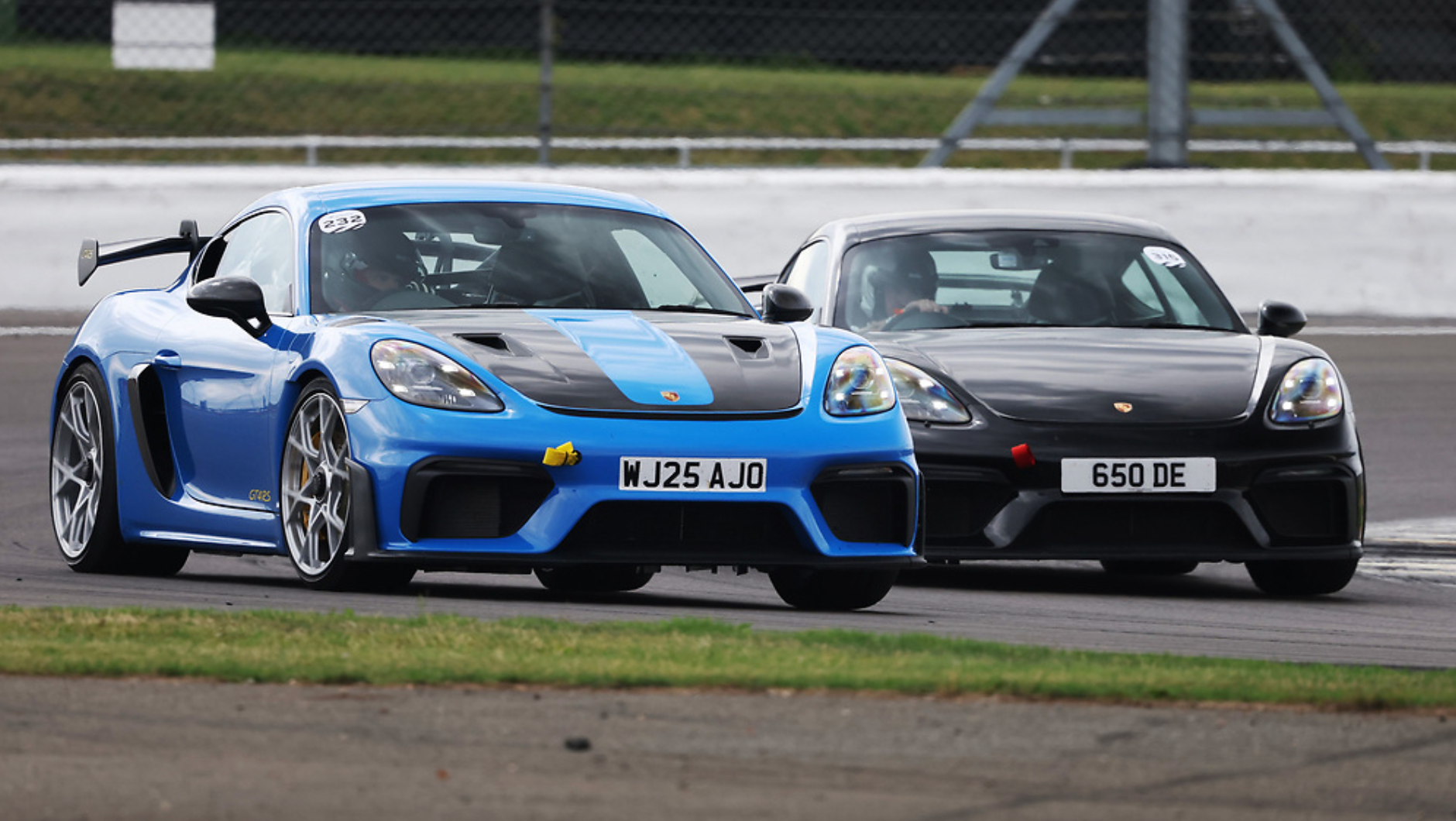 Blue and black Porsche sports cars racing on track, performance parts UK, Eastwood Engineering